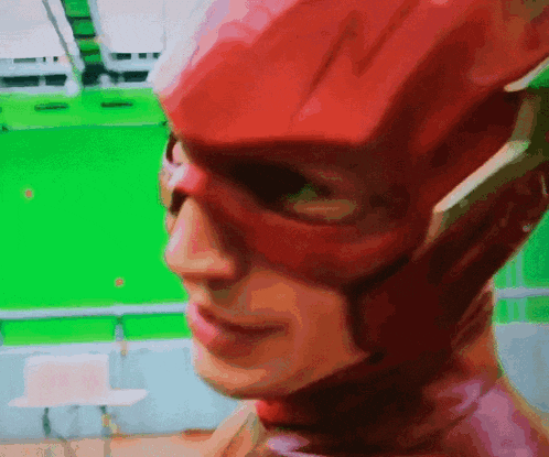 a close up of a person 's face with a red mask on