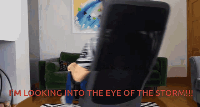 a person is sitting in a chair with the words " i 'm looking into the eye of the storm "