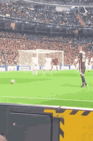 a soccer player with the number 24 on his shorts is kicking a ball
