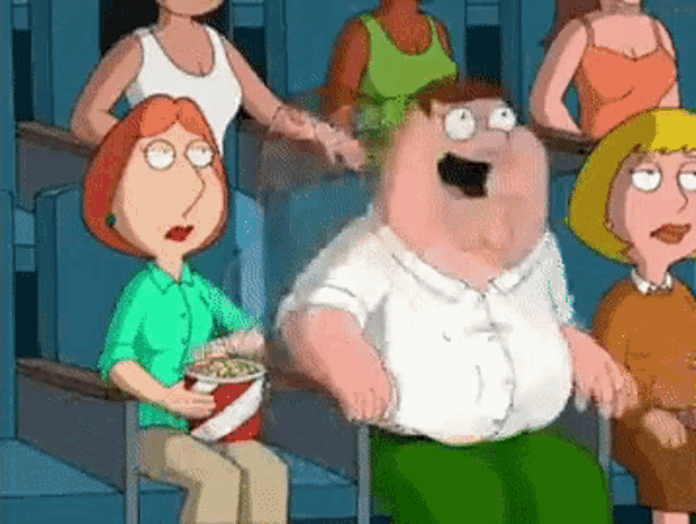a group of cartoon characters are sitting in a theater watching a movie .