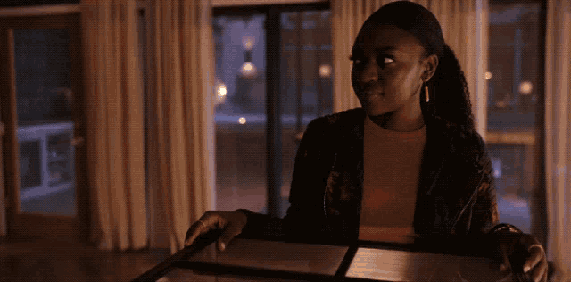 a woman in a brown shirt is smiling while holding a tray