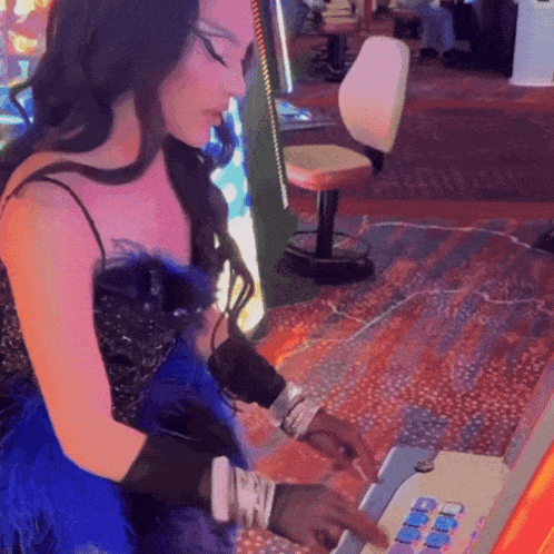 a woman in a blue feathered dress is playing a video game