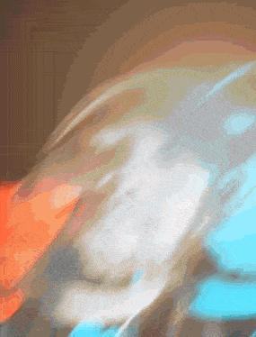 a blurred image of a person 's face with a blue and white background