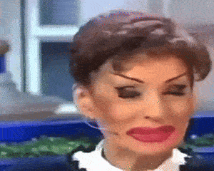 a close up of a woman 's face with red lipstick