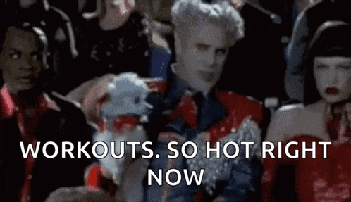 a group of people are sitting in a room with the words " workouts so hot right now " on the screen
