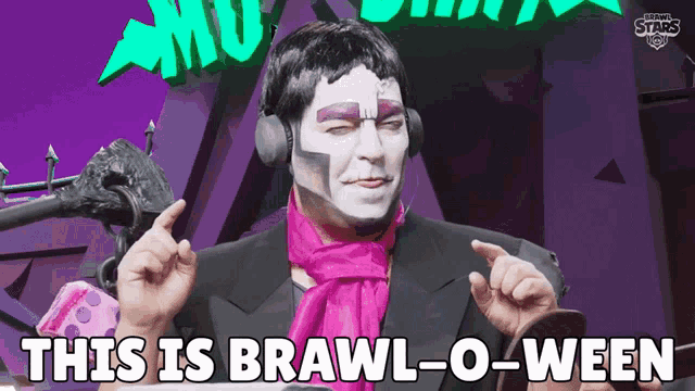 a man wearing headphones and a pink scarf says this is brawl-o-ween