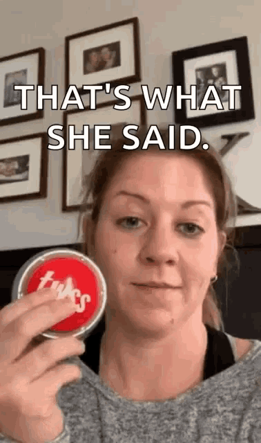 a woman is holding a tin of twizzlers in her hand and says that 's what she said .