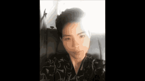 a young man is taking a selfie while sitting on a couch .
