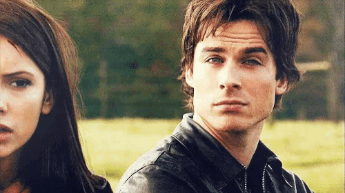 a man and a woman are looking at each other