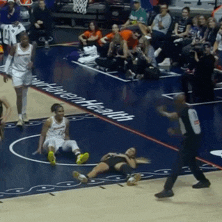 a female basketball player is laying on the floor in front of a written health logo