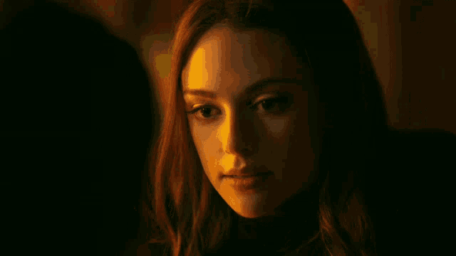 a close up of a woman 's face with her mouth open