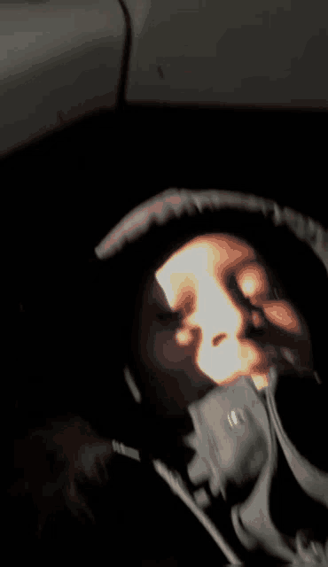 a person wearing a hoodie with the letter m on the front