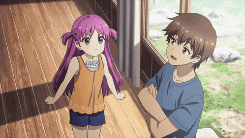 a boy and a girl standing next to each other on a wooden floor