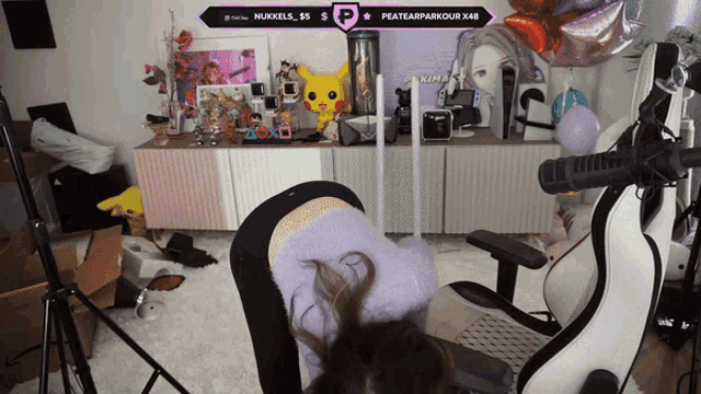 a woman is doing a yoga pose in front of a sign that says ' nukkels_86 $ '