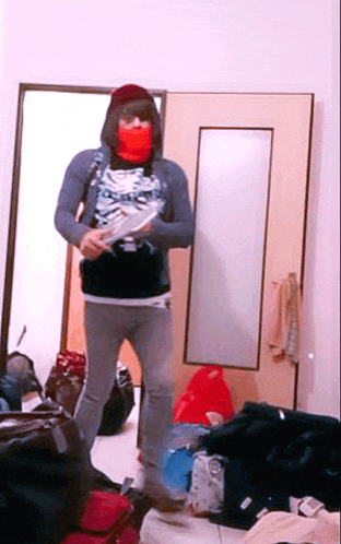 a person wearing a red mask and a skeleton shirt