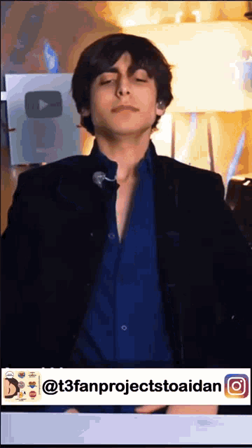 a man in a blue shirt and black jacket is dancing