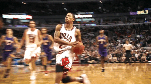 a basketball player wearing a bulls jersey is dribbling the ball