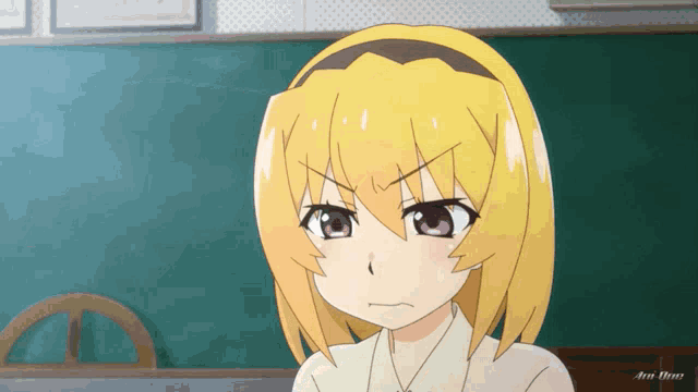 a girl with yellow hair is making a funny face