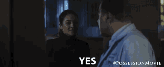 a movie poster for the possession movie shows a man and a woman talking to each other