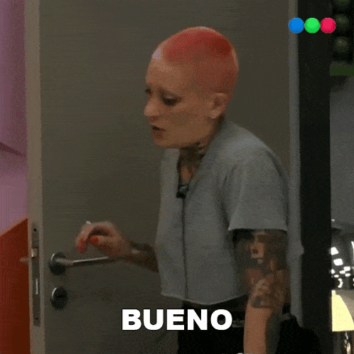 a man opens a door with a pink wall behind him and a sign that says ' abc ' on it