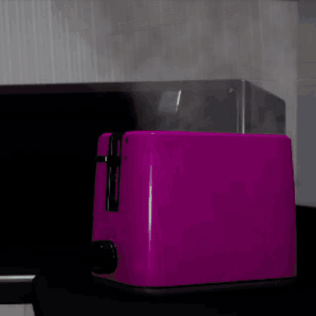 a purple toaster is sitting on a counter