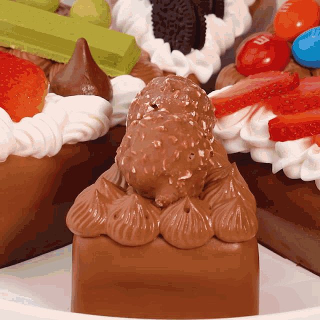 a close up of a chocolate cake with strawberries and m & m 's