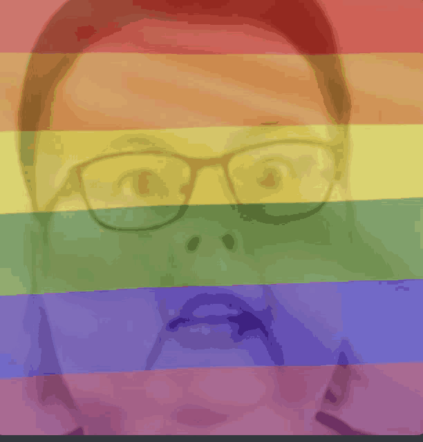 a woman wearing glasses is behind a rainbow colored background