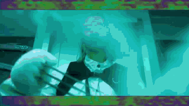 a person is standing in a dark room with a blue light shining on them