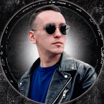 a man wearing sunglasses and a leather jacket stands in a black circle