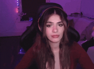 a woman wearing headphones is sitting in a chair in a room .