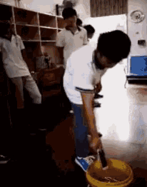 a man is cleaning the floor with a mop