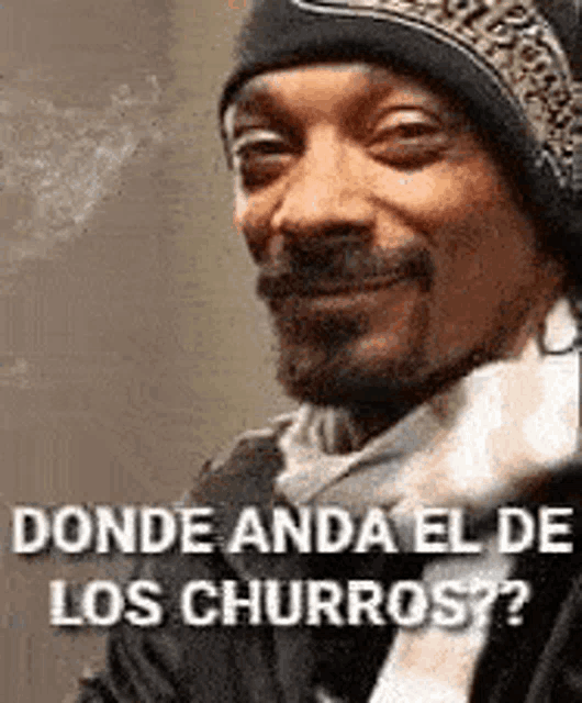 snoop dogg is wearing a beanie and scarf and smiling while talking about churros .