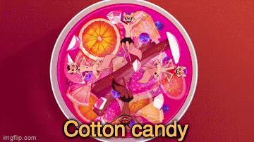 a bowl of cotton candy with orange slices and cinnamon sticks