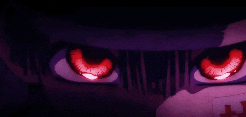 a close up of a person 's eyes with red eyes and a mask on .