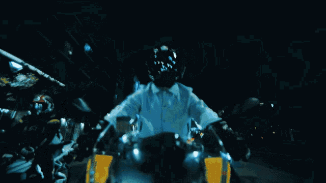 a blurry picture of a person riding a motorcycle with a blue background