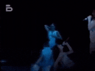 a group of people are dancing on a stage with the number 10 on the bottom
