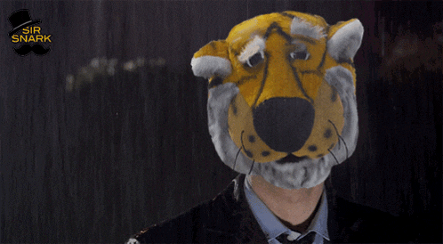 a man in a suit and tie has a tiger mask on his face