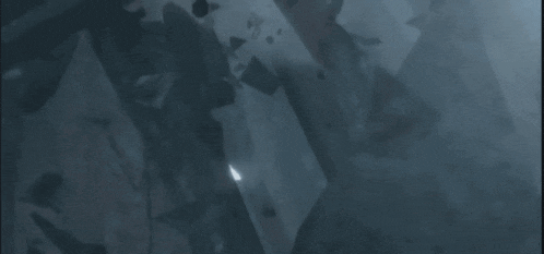 a person is standing in a dark room holding a sword