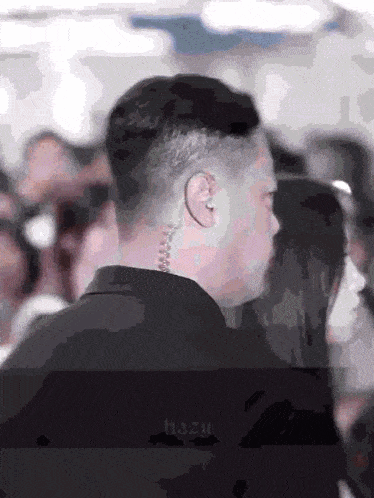 a man wearing ear defenders is standing in a crowd