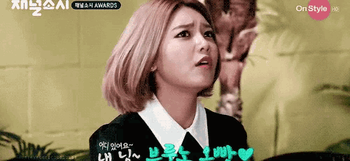 a woman in a black jacket and white collar is on a tv screen that says onstyle hd