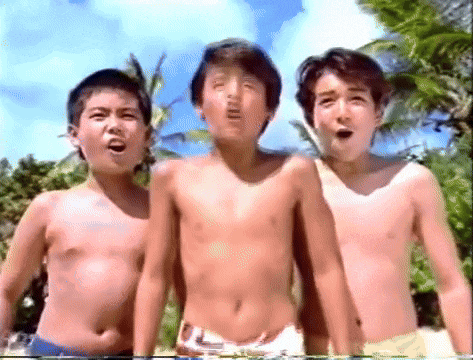 three boys without shirts are standing next to each other