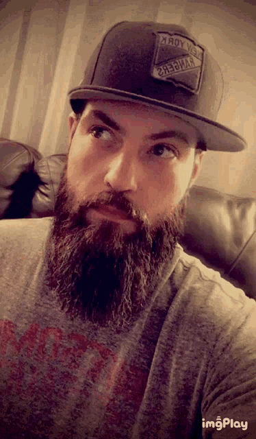 a man with a beard wearing a hat that says roy vans