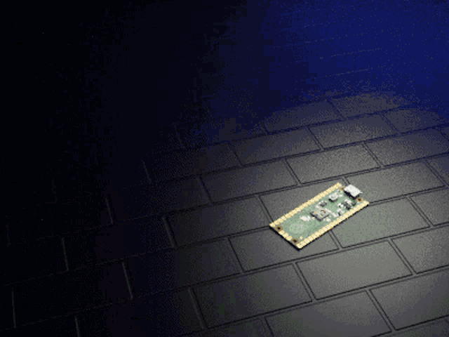 a small electronic device is laying on a tiled floor