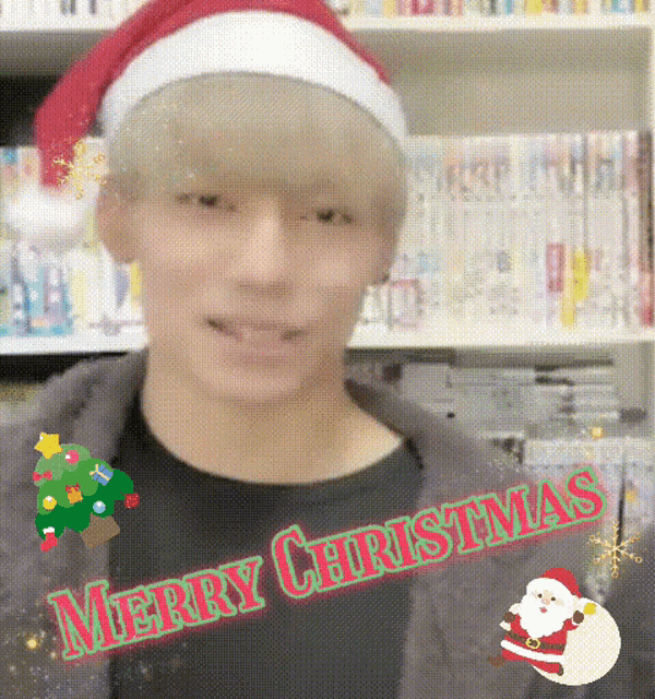 a man wearing a santa hat with the words merry christmas written on it