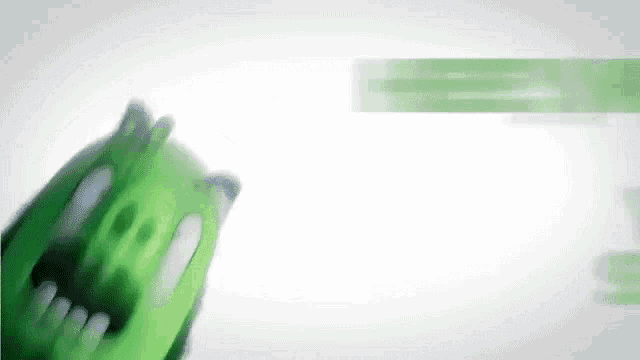 a close up of a green angry bird with its mouth open .