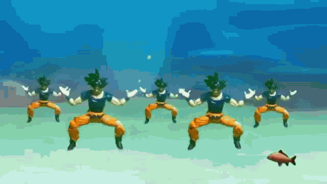 a group of dragon ball z figures are dancing in the water with a fish in the background .