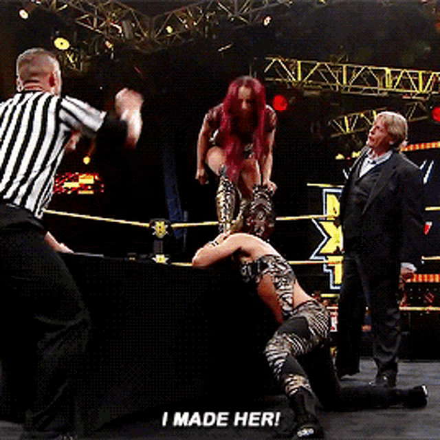 a woman in a wrestling ring with the words i made her on the bottom