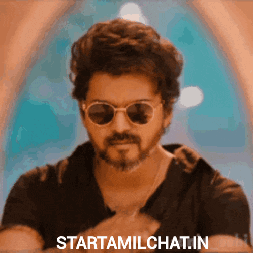 a man wearing sunglasses and a black shirt with the words starttamilchat.in on the bottom right