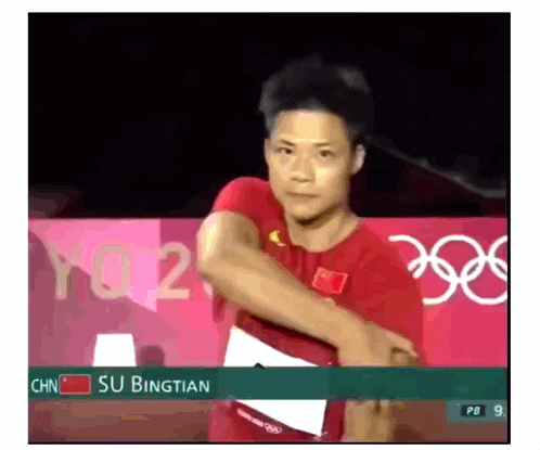 a man in a red shirt is standing in front of a sign that says ' su bingtian ' on it