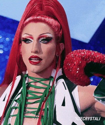 a close up of a drag queen 's face with the word x crystali on the bottom